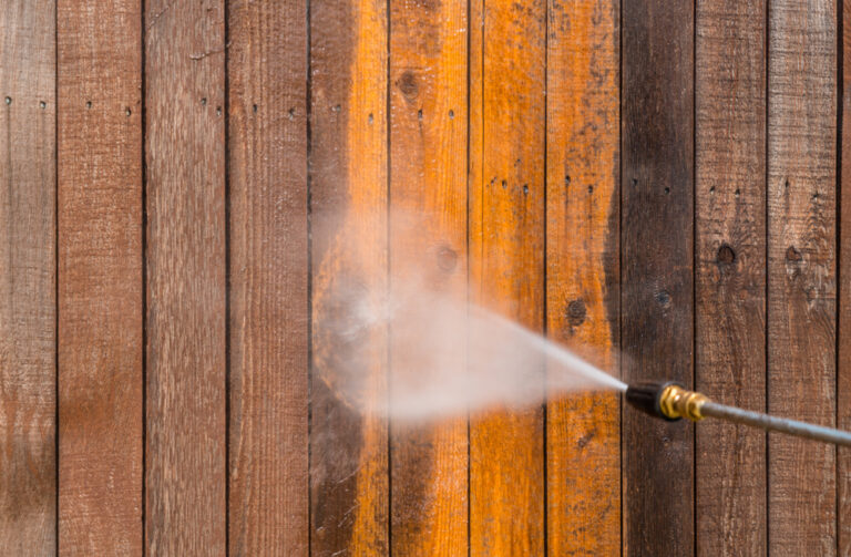 Wooden fence being restored with power washing service
