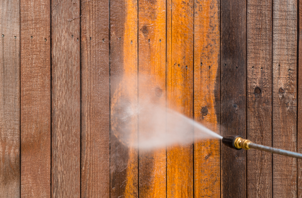 Wooden fence being restored with power washing service