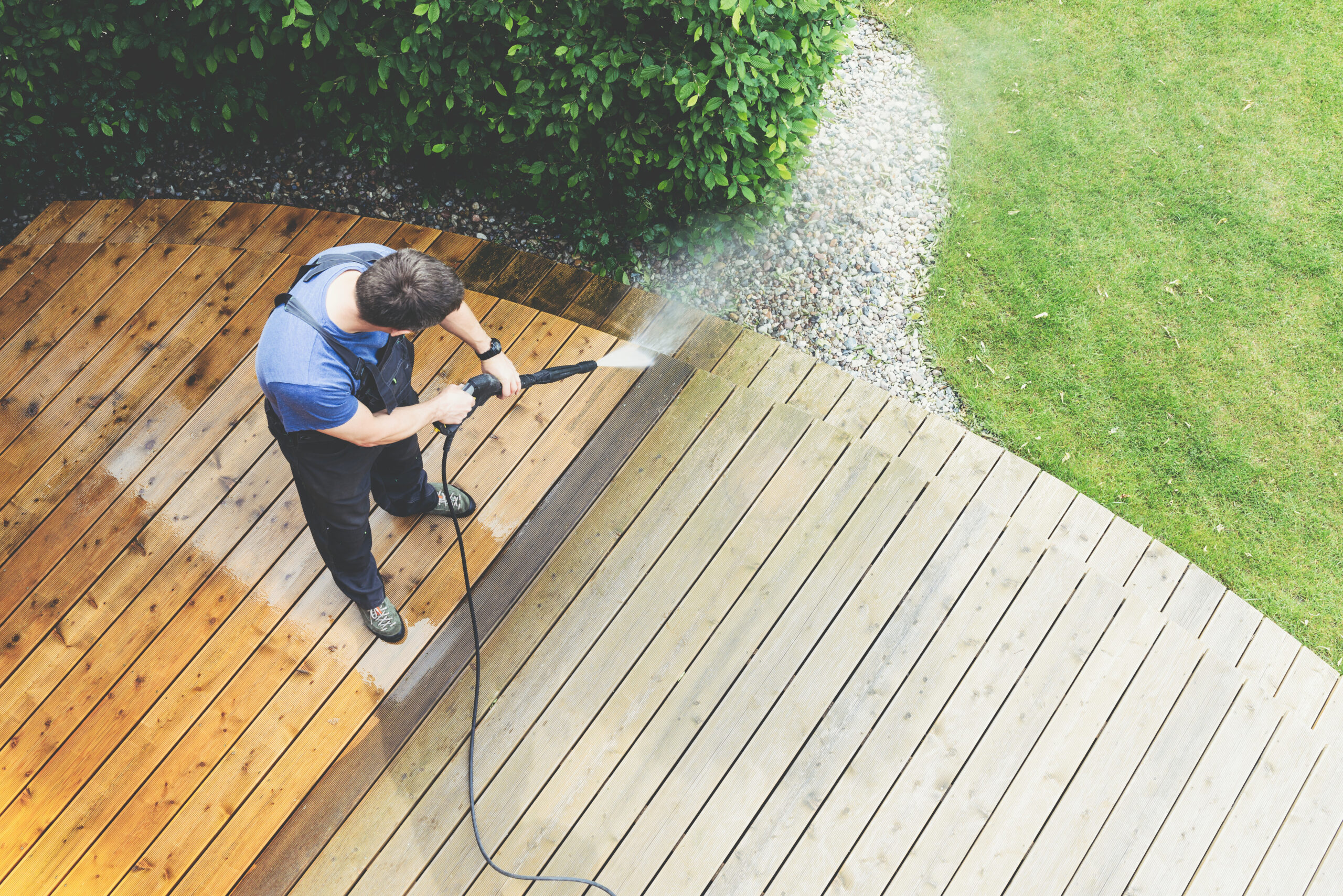 Power washing wooden deck in Westchester NY showing before-and-after cleaning results for improved curb appeal.
