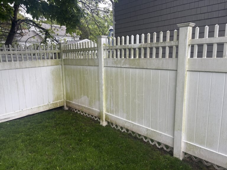 Heavily stained vinyl fence before fence power washing service