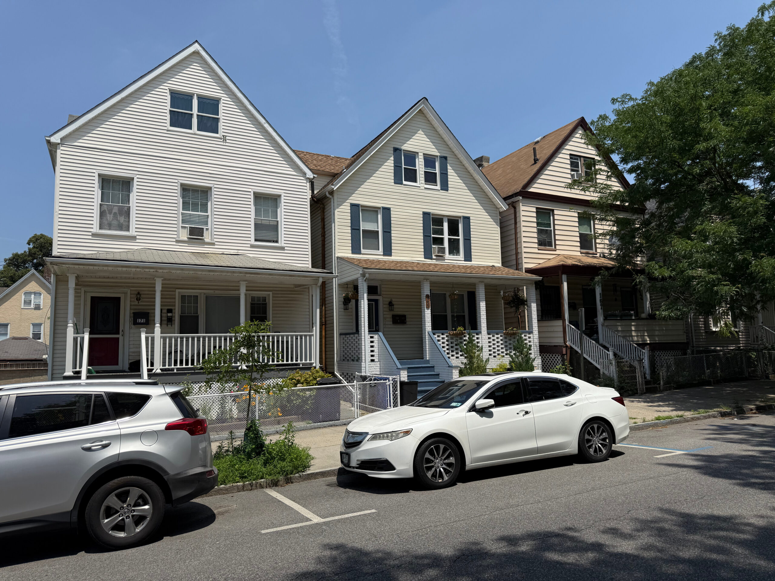 Row of homes on Beekman Avenue in Sleepy Hollow NY with visible siding and porches exposed to dirt and moisture—ideal candidates for pressure washing services.