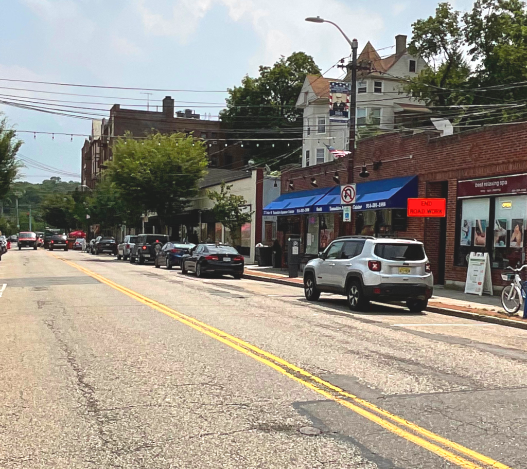 Dobbs Ferry NY power washing company near Main Street storefronts and parked cars