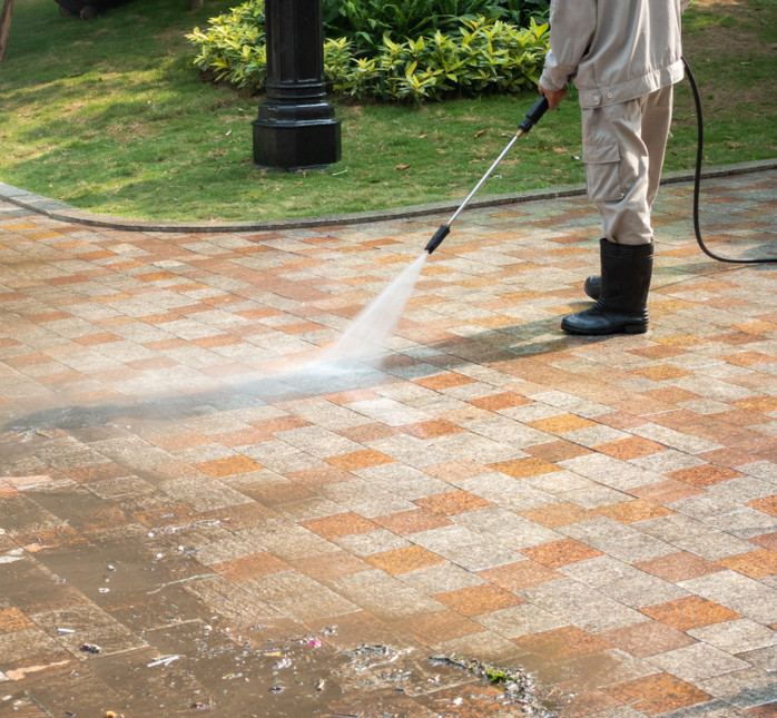 Cleaning paver driveway in Sleepy Hollow NY to remove stains and algae buildup.