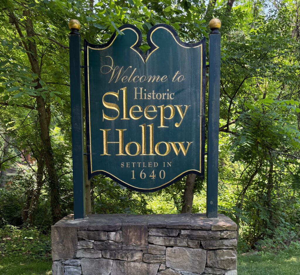 Welcome to Historic Sleepy Hollow sign surrounded by trees – symbolizing the hometown pride served by our Sleepy Hollow NY power washing company.