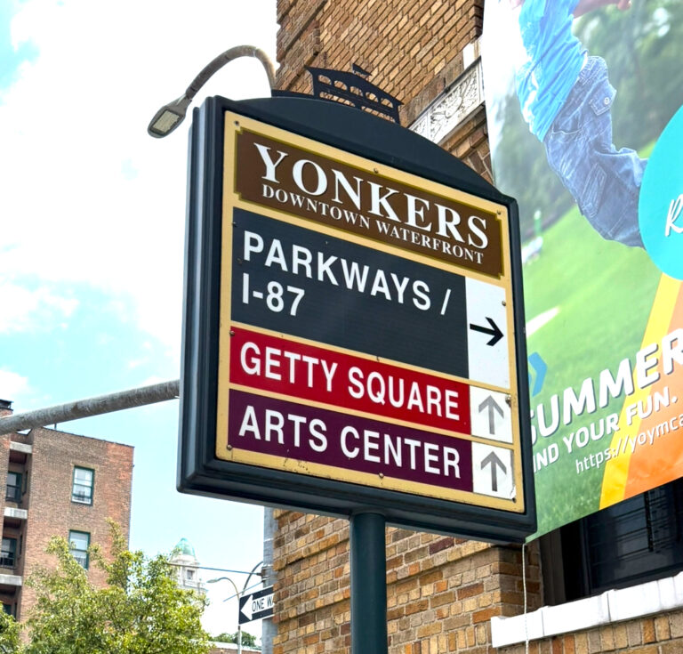 Downtown Yonkers sign near commercial buildings
