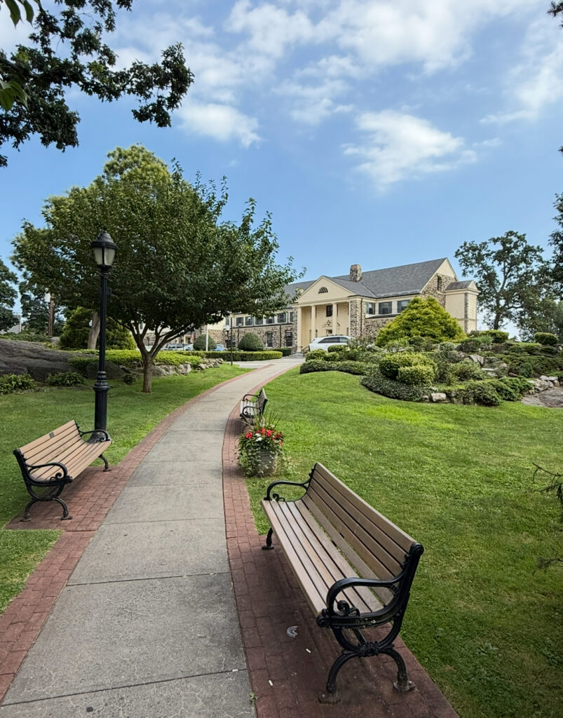 Eastchester NY Town Hall building with landscaped grounds and benches representing community pride