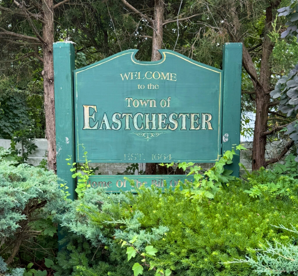 Welcome sign for the Town of Eastchester NY established in 1664 surrounded by greenery