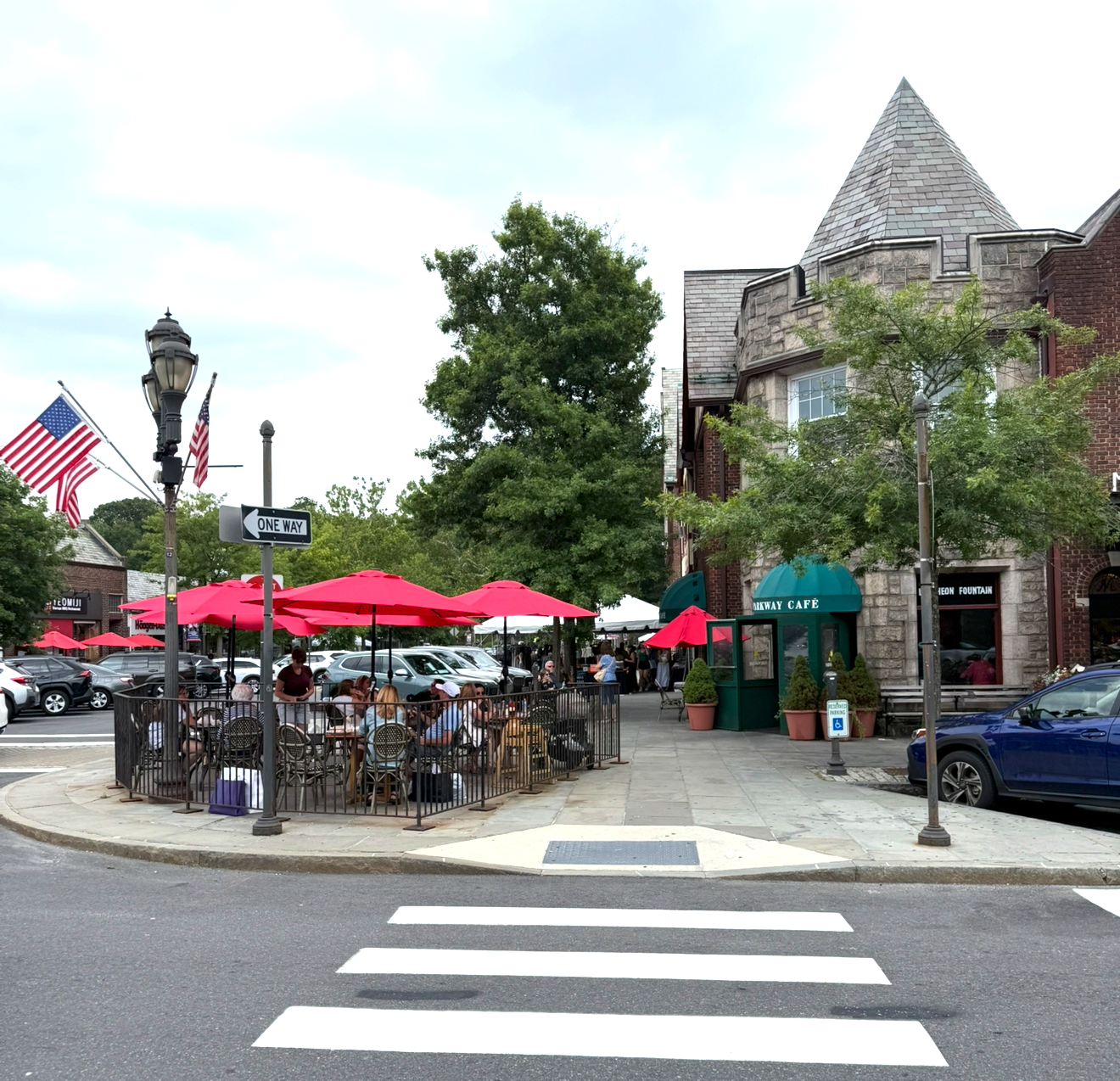 Downtown Scarsdale Village in New York with outdoor dining, shops, and historic architecture.