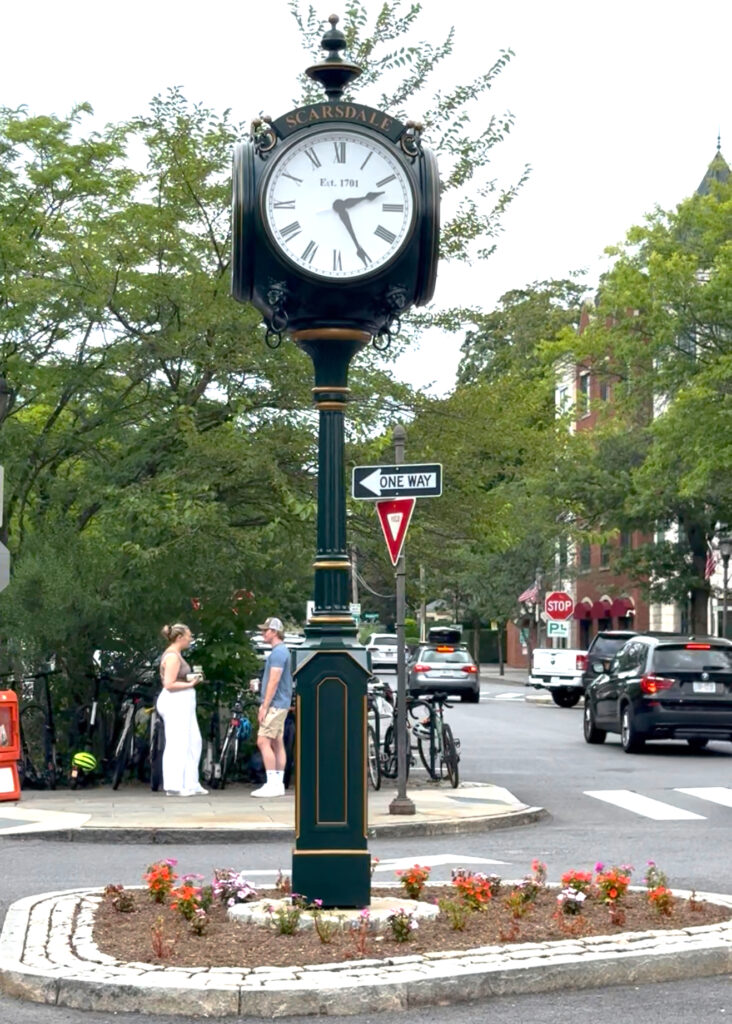 Historic Scarsdale Village clock in downtown, a central landmark surrounded by shops, cafes, and vibrant community life.