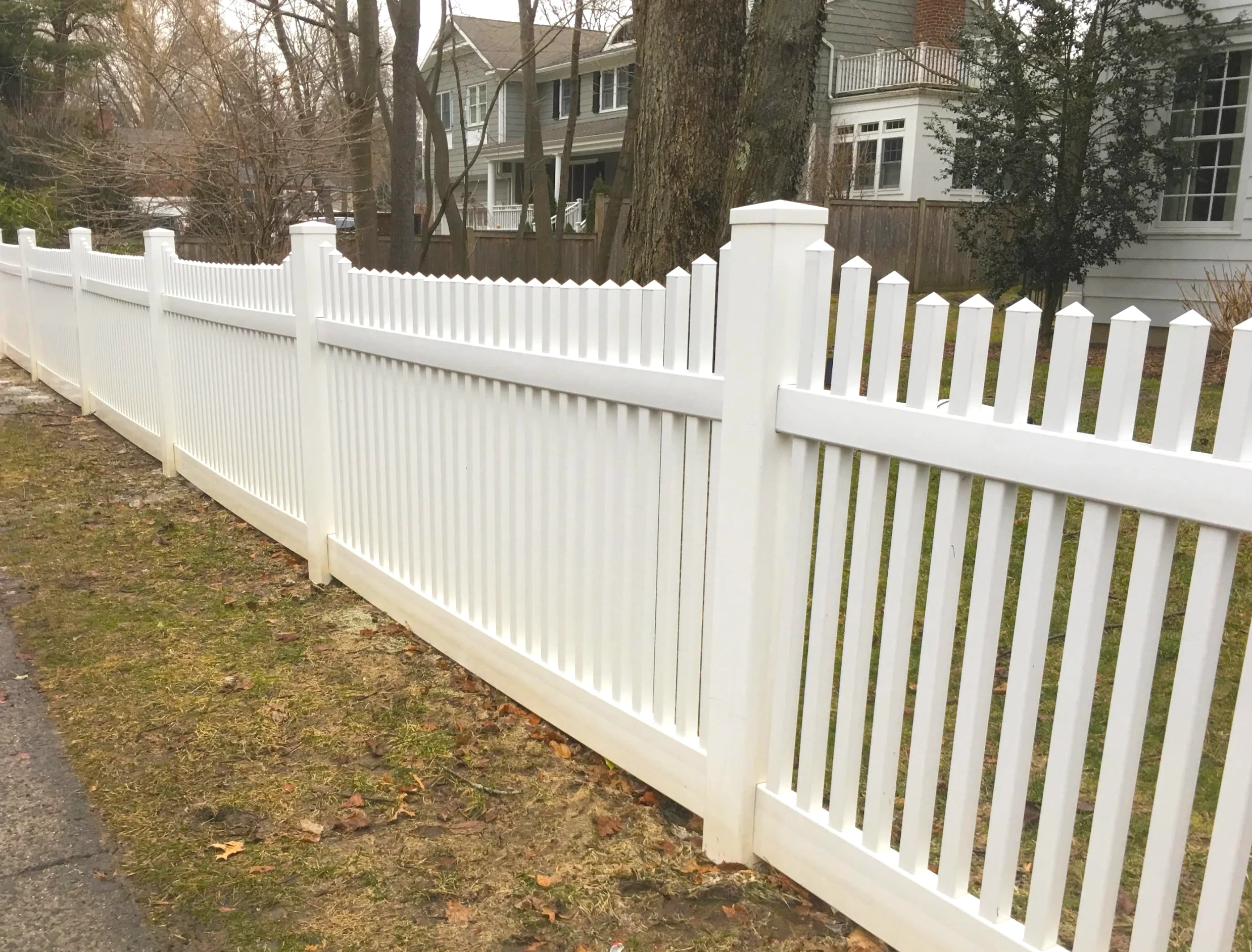Clean white vinyl fence after professional power washing in Yonkers, NY